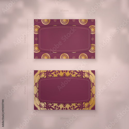 Burgundy business card with mandala gold pattern for your business. photo