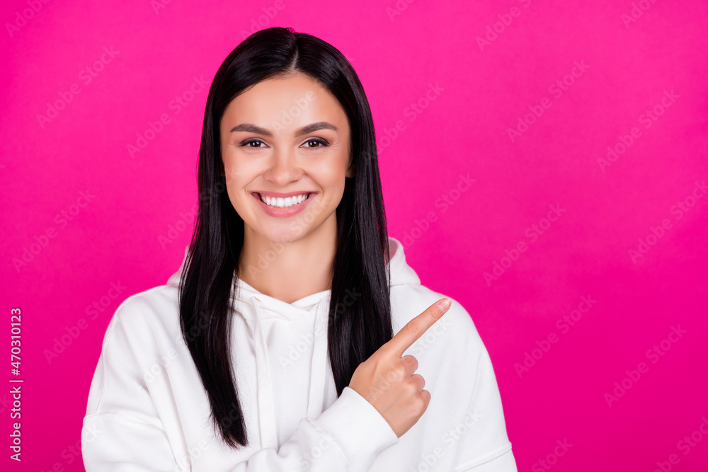 Photo of young millennial girl indicate finger empty space advice promo isolated over magenta color background Photo of young millennial girl indicate finger empty space advice promo isolated over magenta color background