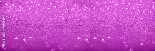 Defocused violet glittering background with shinig bokeh.Large banner with negative space.