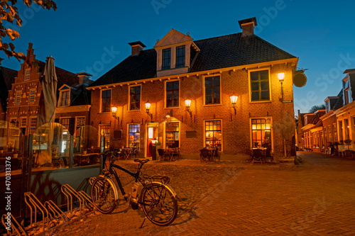 Historical buildings in the city Sloten in the Netherlands at night photo