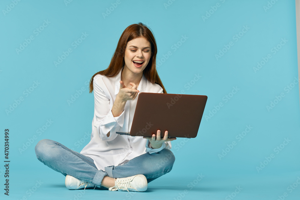 woman with laptop sitting on the floor learning student technology blue background woman with laptop sitting on the floor learning student technology blue background