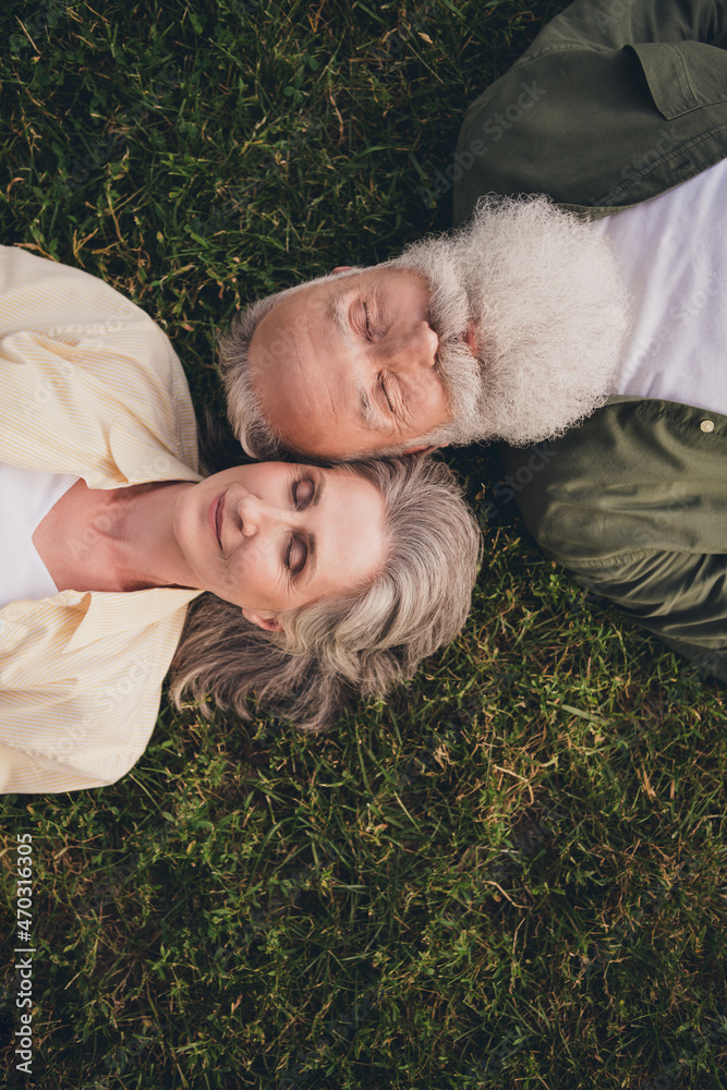 Vertival photo of rest pensioner grey hair couple wear trend shirts outside spend free time Vertival photo of rest pensioner grey hair couple wear trend shirts outside spend free time