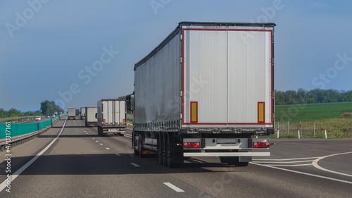 Trucks Driving on Country Highway