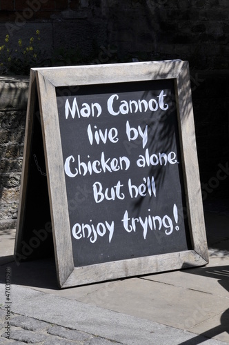 Cheeky message on a board advertising food outside a restaurant in London,United Kigdom. photo