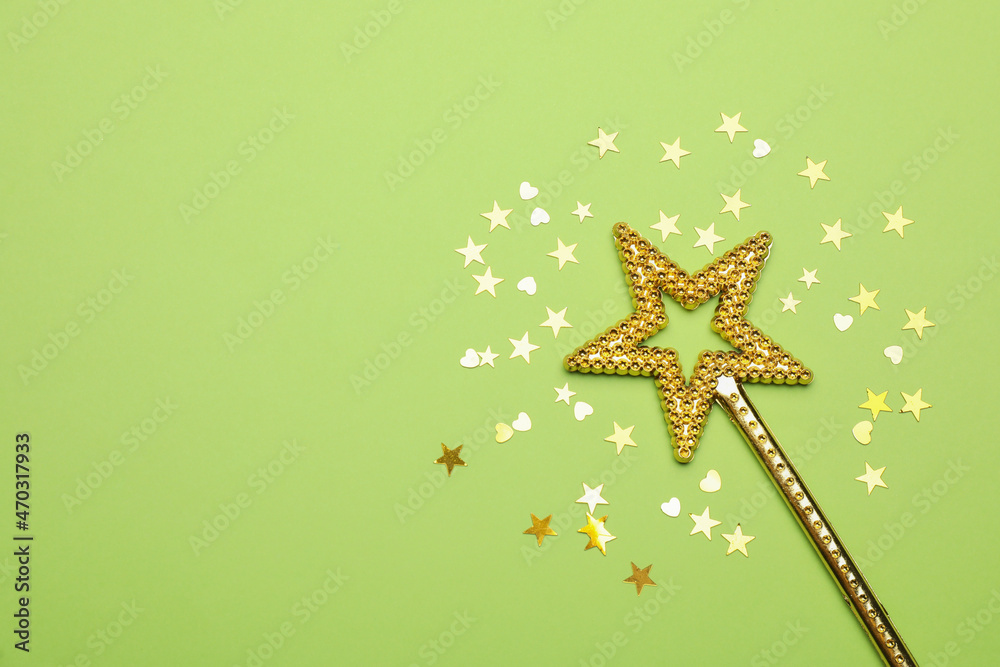 Beautiful golden magic wand and confetti on light green background, flat lay. Space for text Beautiful golden magic wand and confetti on light green background, flat lay. Space for text