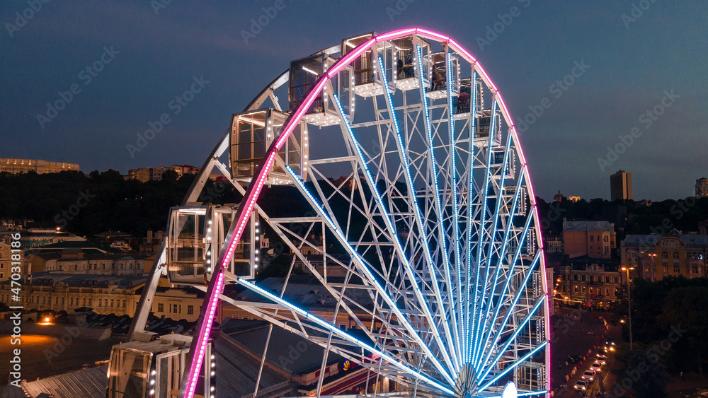 Illuminated Ferris Wheel at Night in Kyiv, Ukraine