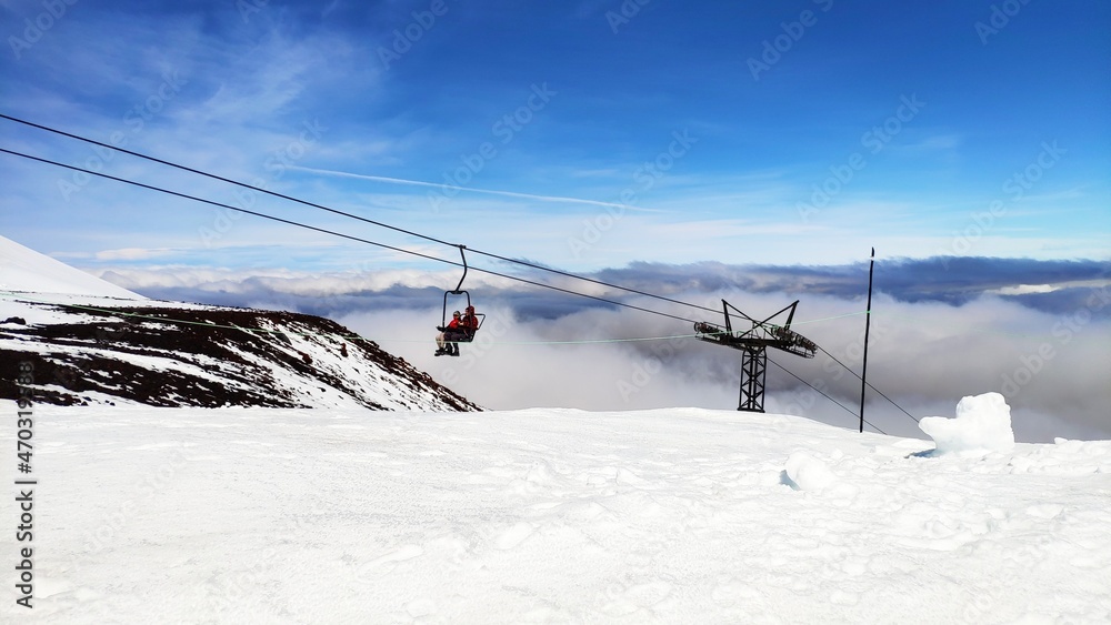Ski lift reaching the top of Osorno Volcano above the clouds, southern Chile, Patagonia.