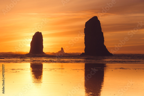 Orange sunset behind the needles at Cannon beach