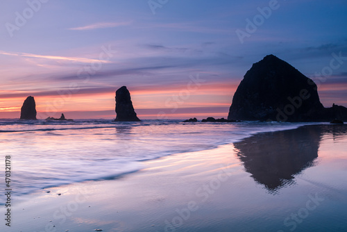 Waves in front of Cannon beach haystack at sunset