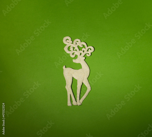 Christmas white deer on a green background. Creative concept.