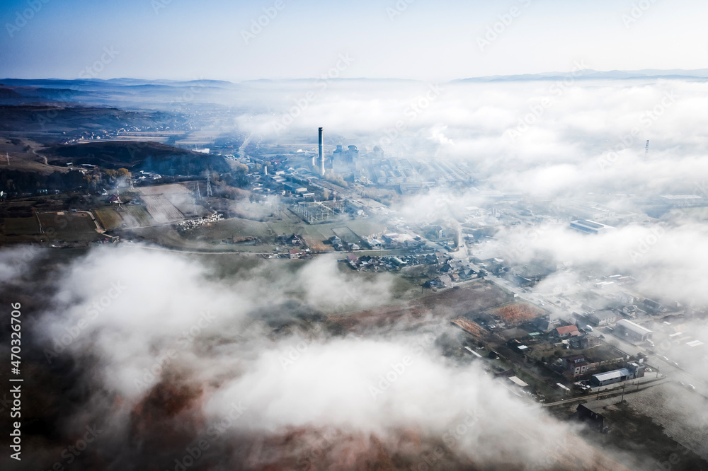 Obraz premium Aerial view of industrial zone covered with autumn fog in Dej, Romania.