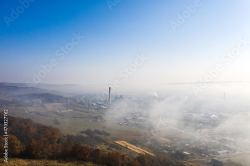 Aerial view of industrial zone covered with autumn fog in Dej, Romania.