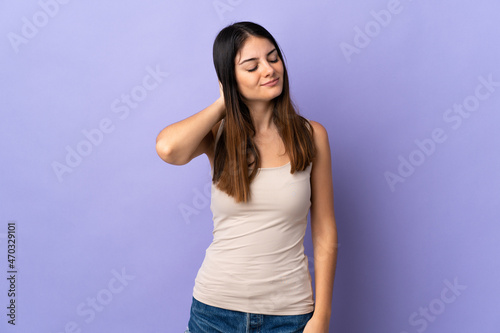 Young caucasian woman isolated on purple background with neckache