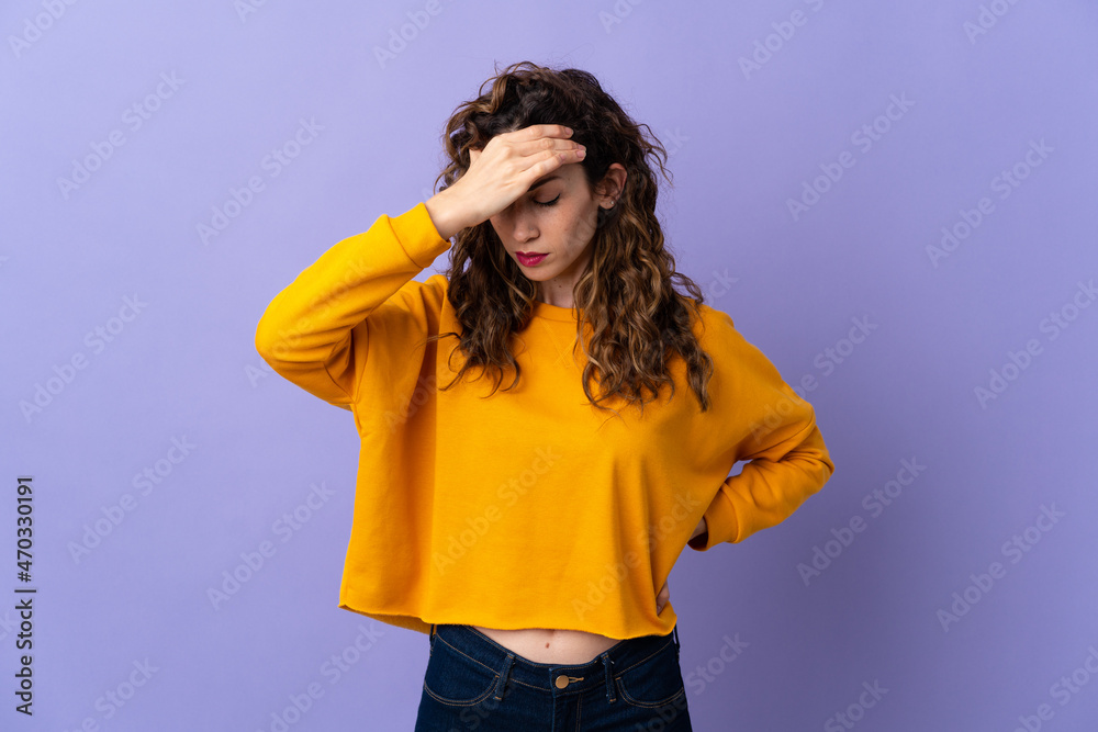 Young caucasian woman isolated on purple background with headache