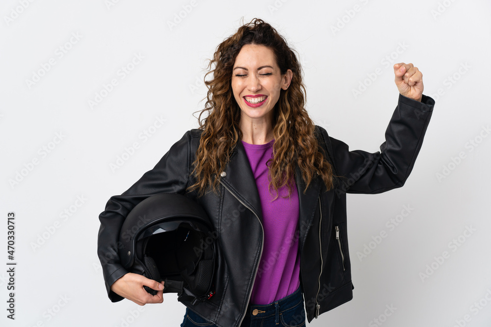 Young caucasian woman holding a motorcycle helmet doing strong gesture Young caucasian woman holding a motorcycle helmet doing strong gesture