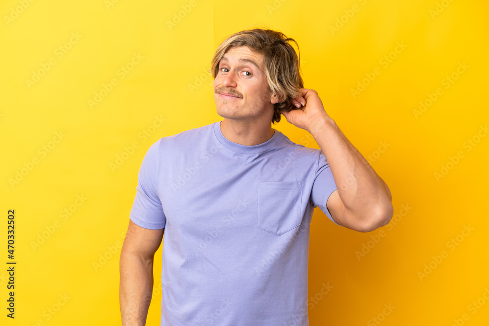 Handsome blonde man isolated on yellow background having doubts Handsome blonde man isolated on yellow background having doubts