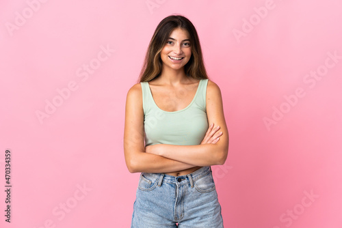Young caucasian woman isolated on pink background keeping the arms crossed in frontal position © luismolinero