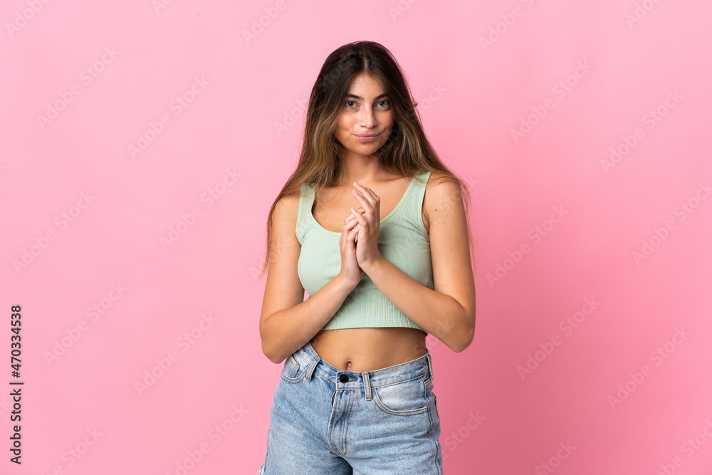 Young caucasian woman isolated on pink background scheming something Young caucasian woman isolated on pink background scheming something