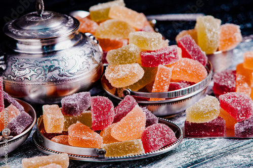 Dessert marmalade in the form of lemon and orange slices. The sweetness of jelly candy. photo