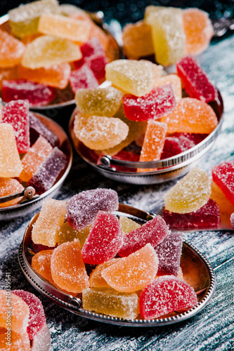 Dessert marmalade in the form of lemon and orange slices. The sweetness of jelly candy. photo