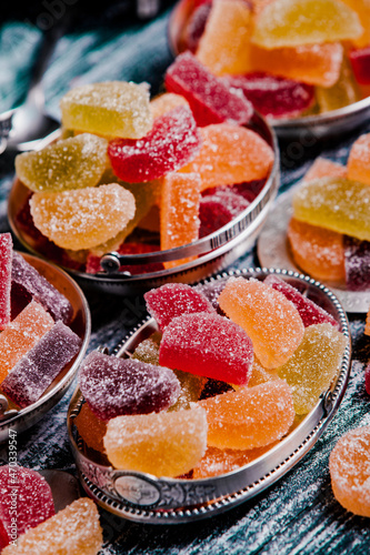 Dessert marmalade in the form of lemon and orange slices. The sweetness of jelly candy. photo