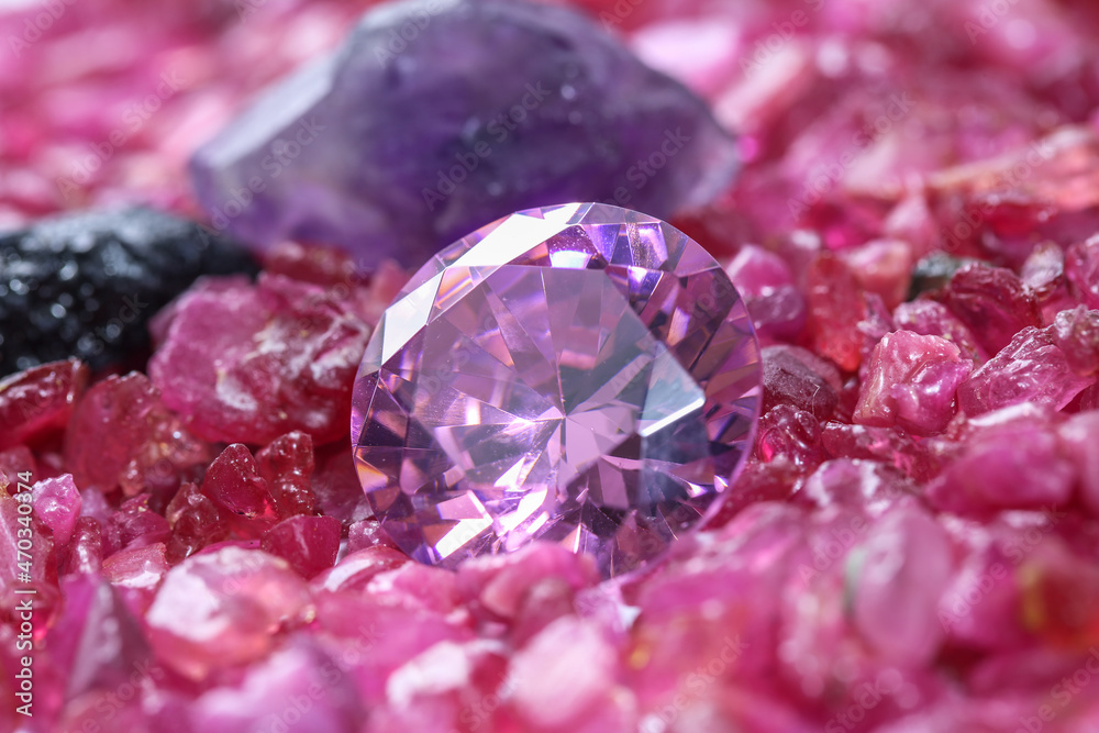 amethyst diamonds on placed on a pile of raw ruby rough gemstone..colorful raw stone background.lived a life of luxury. amethyst diamonds on placed on a pile of raw ruby rough gemstone..colorful raw stone background.lived a life of luxury.