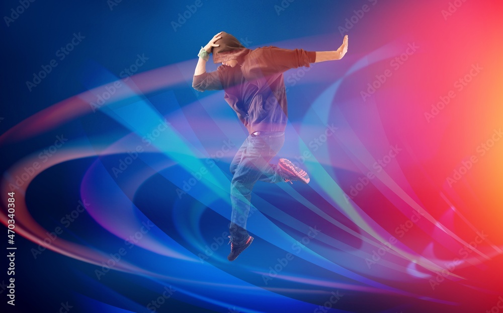Dancing male standing in colourful neon studio light. Dancing male standing in colourful neon studio light.