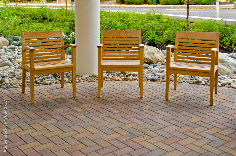 Three chairs next to the entrance to building Three chairs next to the entrance to building