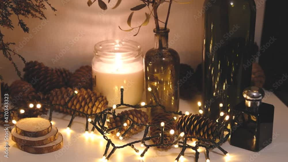 Christmas decorations, flashing lights, New Year 2022, 4k background. Xmas candle, fir cones, bottles Christmas decorations, flashing lights, New Year 2022, 4k background. Xmas candle, fir cones, bottles