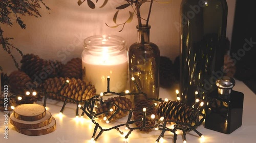 Christmas decorations, flashing lights, New Year 2022, 4k background. Xmas candle, fir cones, bottles