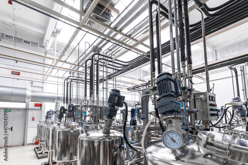 Photo of pipes and tanks. Chemistry and medicine production. Pharmaceutical plant. Interior of a high-tech factory, modern production