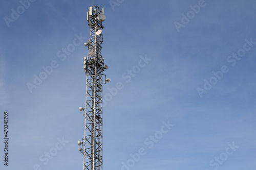 Communication tower on a blue sky background, selective focus