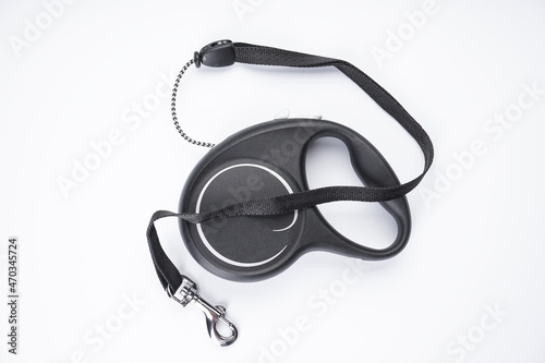 Retractable leash for dogs on a white background, flat lay.