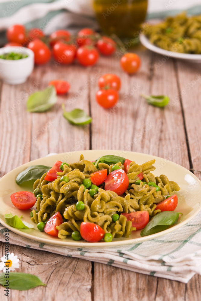 Fusilli pasta with cherry tomatoes and peas.
Fusilli pasta with cherry tomatoes and peas.