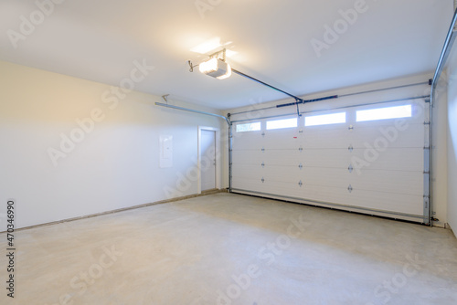 Fotografie, Tablou An empty garage with door and windows.
