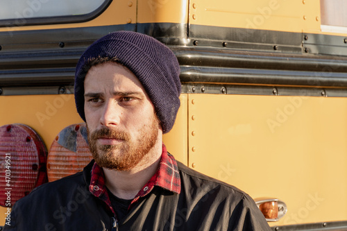 Young stylish hipster man staring out when exiting a bus