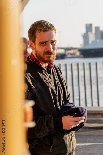 Young stylish hipster man getting out of an old yellow bus