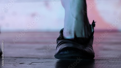 a girl puts on dancing shoes