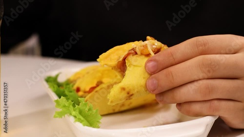 hand holding a slice of bread