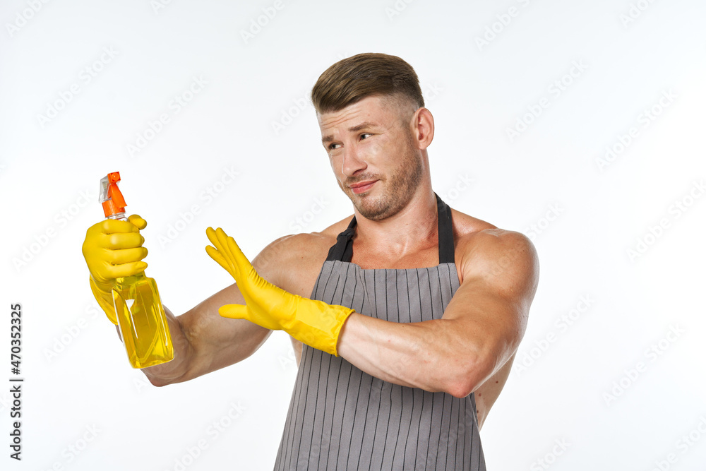 emotional man in apron with detergent cleaning housework