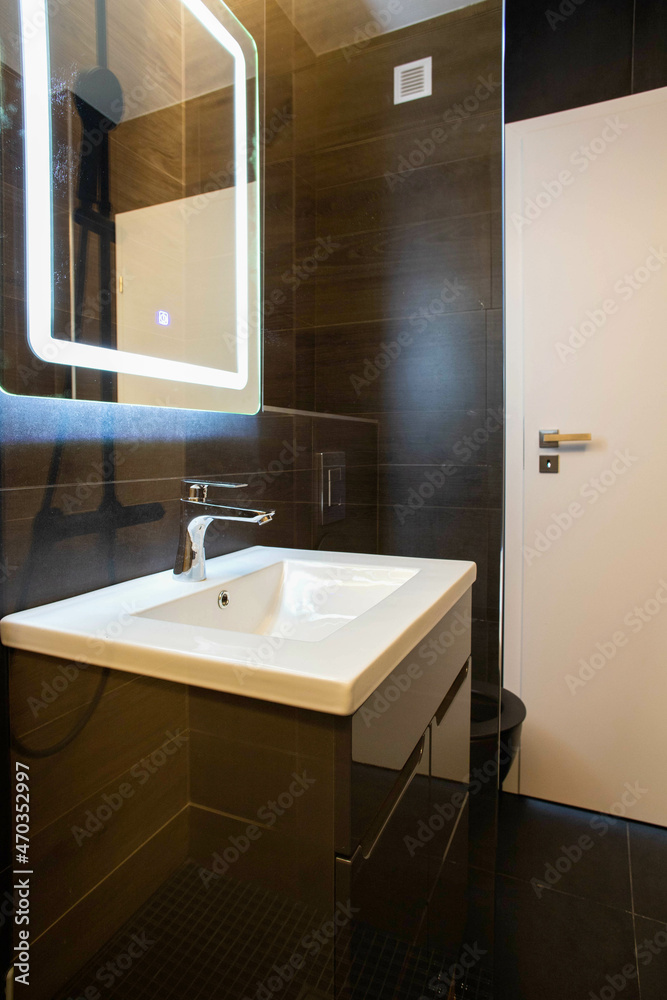 modern bathroom with dark furniture and spotlights modern bathroom with dark furniture and spotlights