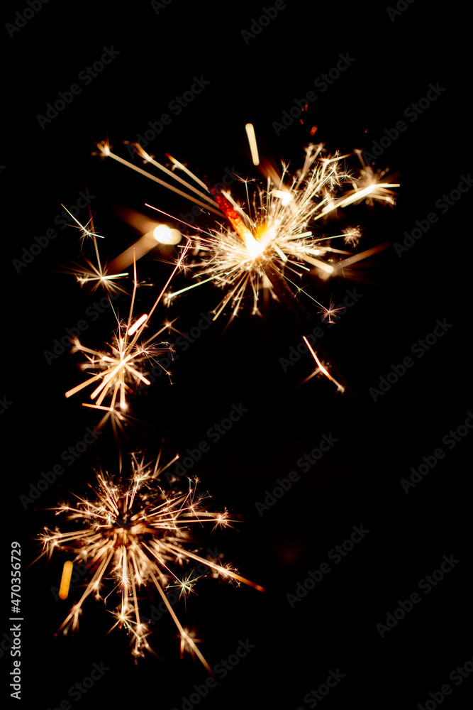 One bengal fire sparkles against the black background.