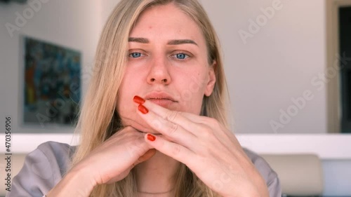 Facebuilding. Double chin problem. Portrait of a young attractive blonde woman doing a facial massage with her fingers. Self-care. Combating age-related changes. 4k, slow motion