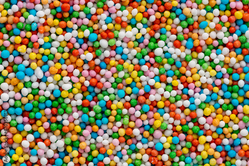 Thousands sprinkles tiny sugar beads for decorating cakes and desserts background.