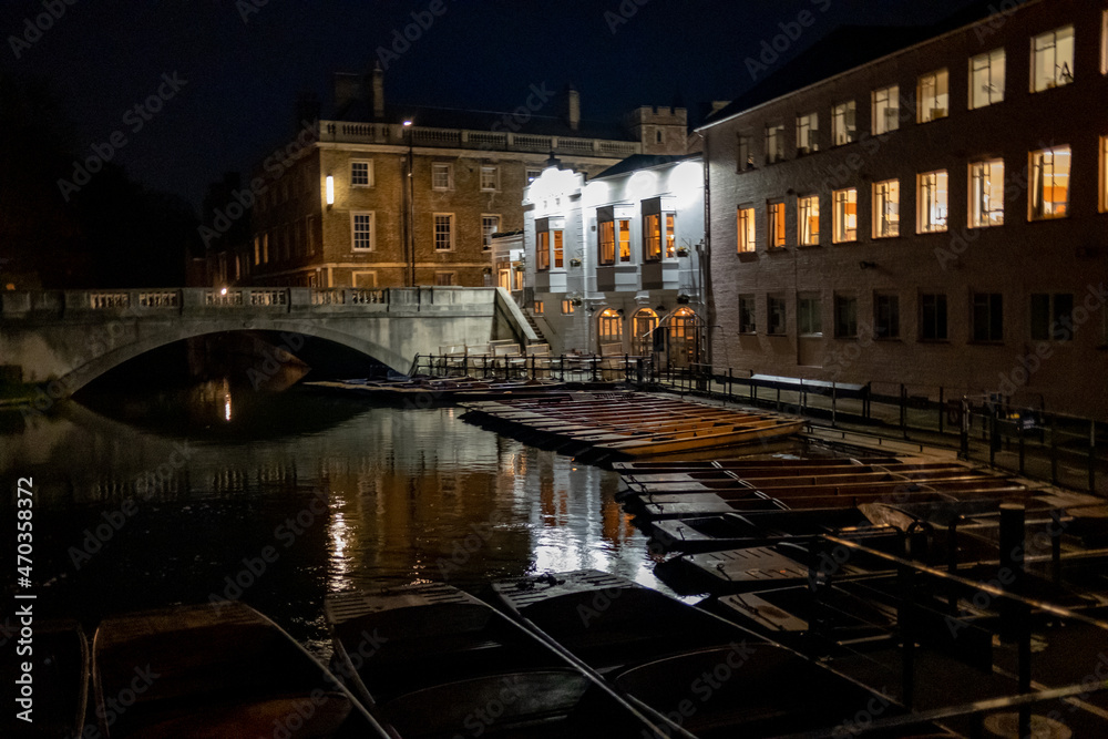 Cambridge, Cambridgeshire, UK – November 16 2021. Traditional punts moored up on the River Cam in Cambridge at night