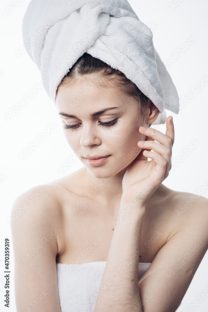 woman after shower with towel on head posing skin care