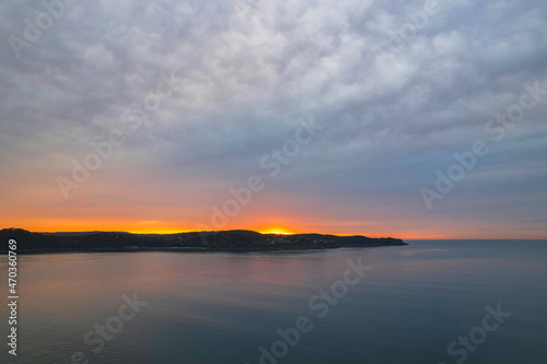 One hundred percent cloud covered sunrise over the sea © Merrillie