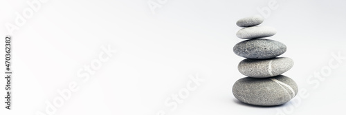 Stone cairn on light background, stones tower, simple poise stones. Purity harmony and Balance Concept. Banner.