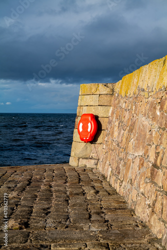 BUCKIE, MORAY, SCOTLAND - 19 NOVEMBER 2021: This is the sun shining on the old parts of Buckpool Harbour within Buckie, Moray, Scotland on 19 November 2021. photo