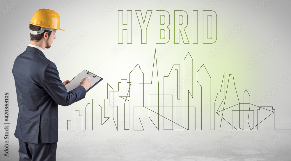 Businessman in hard hat holding blueprint Businessman in hard hat holding blueprint